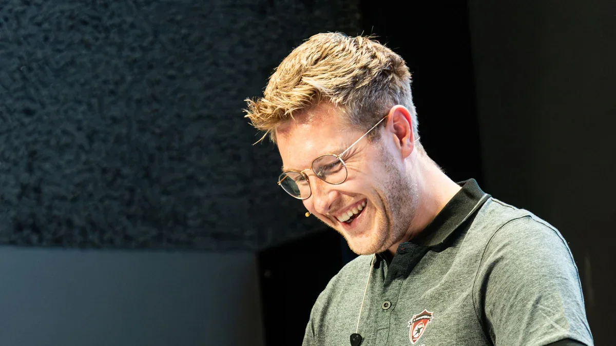 Jannik Reinhard speaking at a conference for the Microsoft Intune and AI Blog