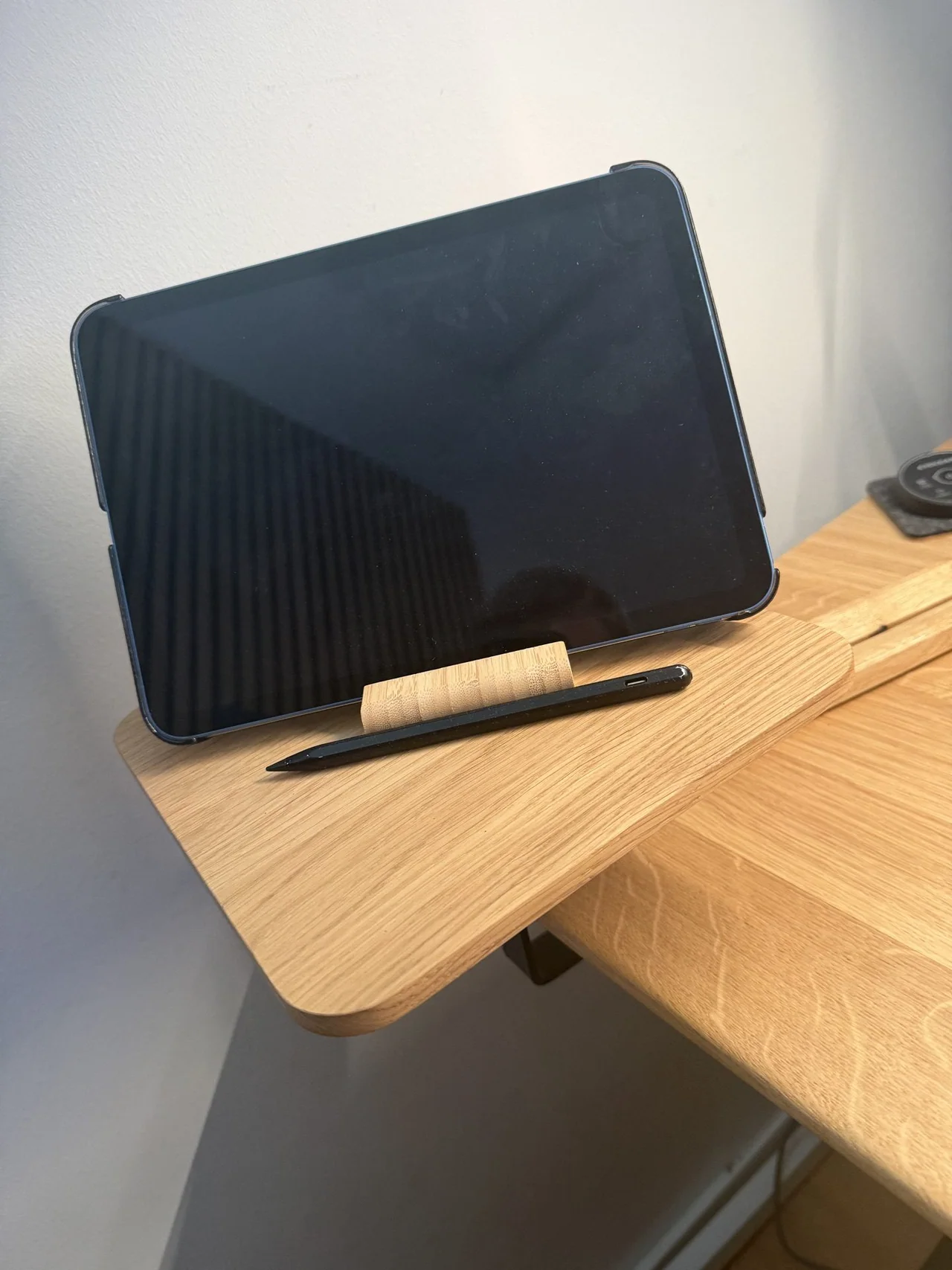 iPad and Apple Pencil on the wooden side shelf in my desk setup 2026